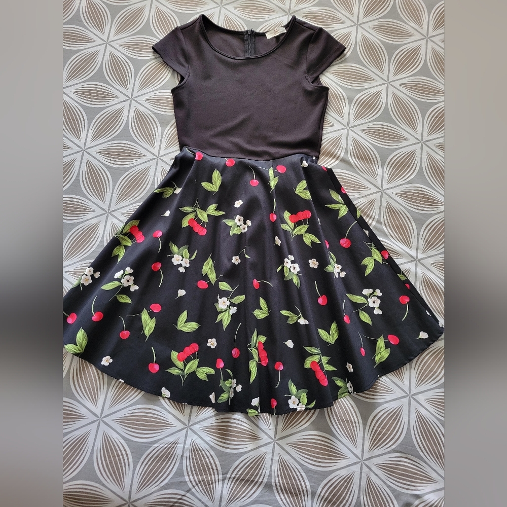 Cute party dress. Fitted top with flare skirt. Lovely floral print on the skirt.